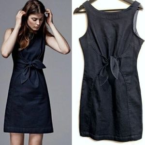 Holding Horses denim ribbon from tie bow dress